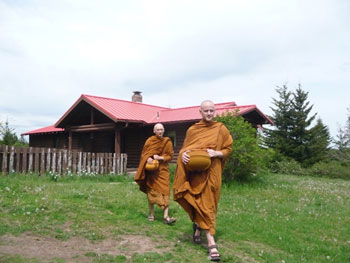 Ajahn Sudanto and Ajahn Karunadhammo get the feel of going on alms rounds during an early visit to Pacific Hermitage in May.
