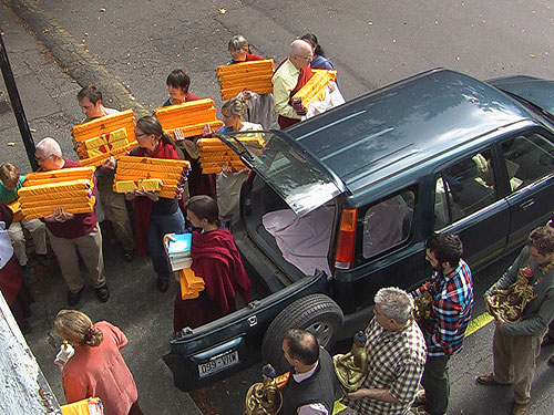 Sangha members prepare to carry holy scriptures and Buddha statues in procession to the new center.