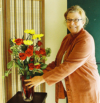 Susan Baldwin, Lama Padma's wife, places a flower offering in the new center.