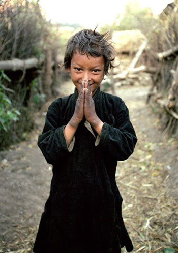 The original photo of “Namaste boy”, Gyeni Bohara, taken in 2000 in the remote Humla region of Nepal.